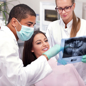 dentist showing patient x-ray during dental exam