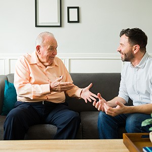 An older man pointing out his beautiful dentures