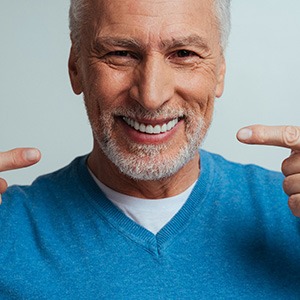 A mature woman speaking with others in a business meeting