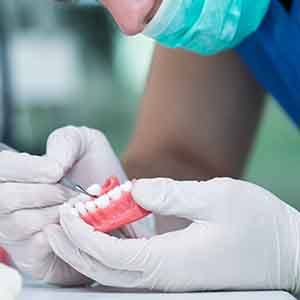 A lab worker making dentures 