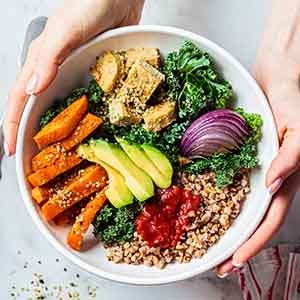 Patient holding bowl filled with healthy foods