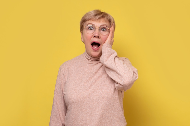 Older patient looking shocked after their denture broke