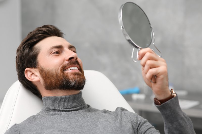 man smiling after receiving dental crown